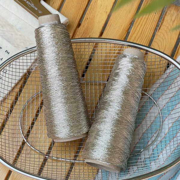 Shiny silver and gold yarn woven INS thread